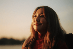 A woman with long hair smiling softly