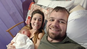 Laura and Sam with newborn Cleo in hospital after her birth.