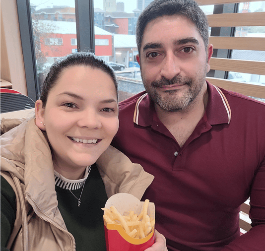 Reka and Jerry with McDonald’s fries on embryo transfer day during IVF treatment with Care Fertility Woking.