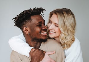 Couple embracing plain background