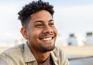 POC man smiling beach background-1