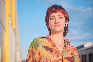 Short haired woman sky background