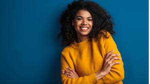 Black woman smiling confidently, representing fertility health awareness and Black maternal health disparities in the UK